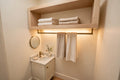 Custom lit hard maple towel shelf — open storage