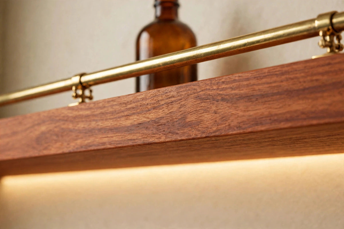 Custom lit sapele shelf with brass rail — open storage