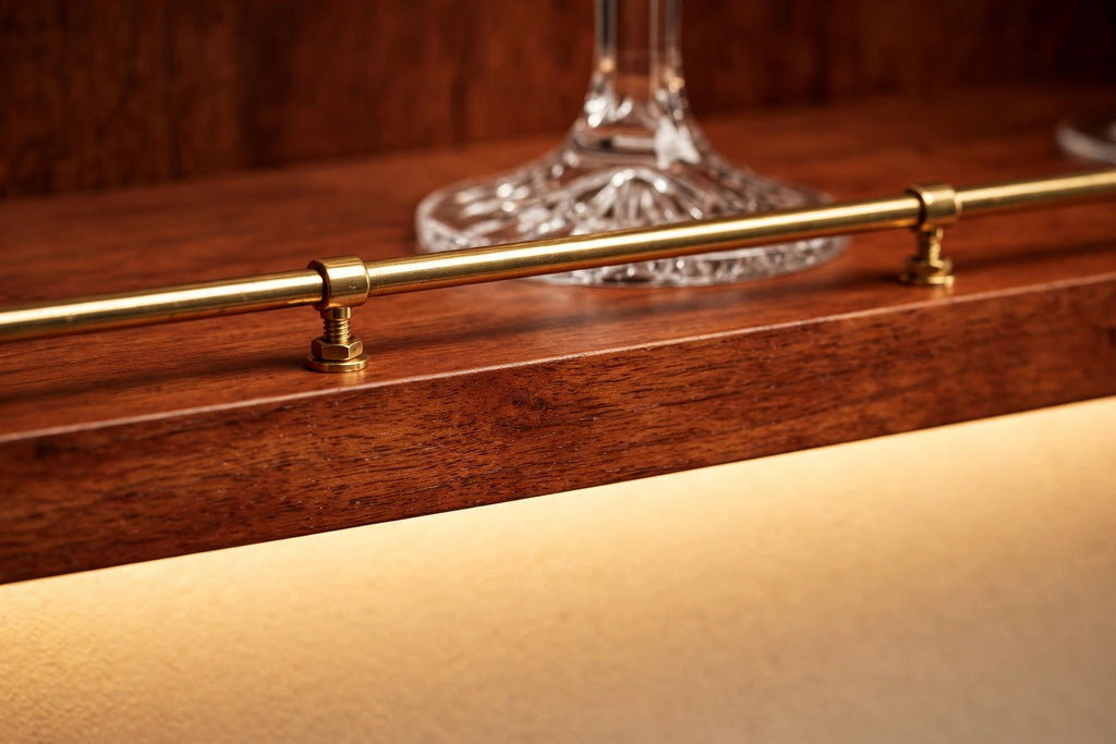 Custom lit cherry shelf with brass rail — open storage