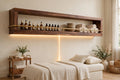Custom lit walnut shelf with brass rail — open storage