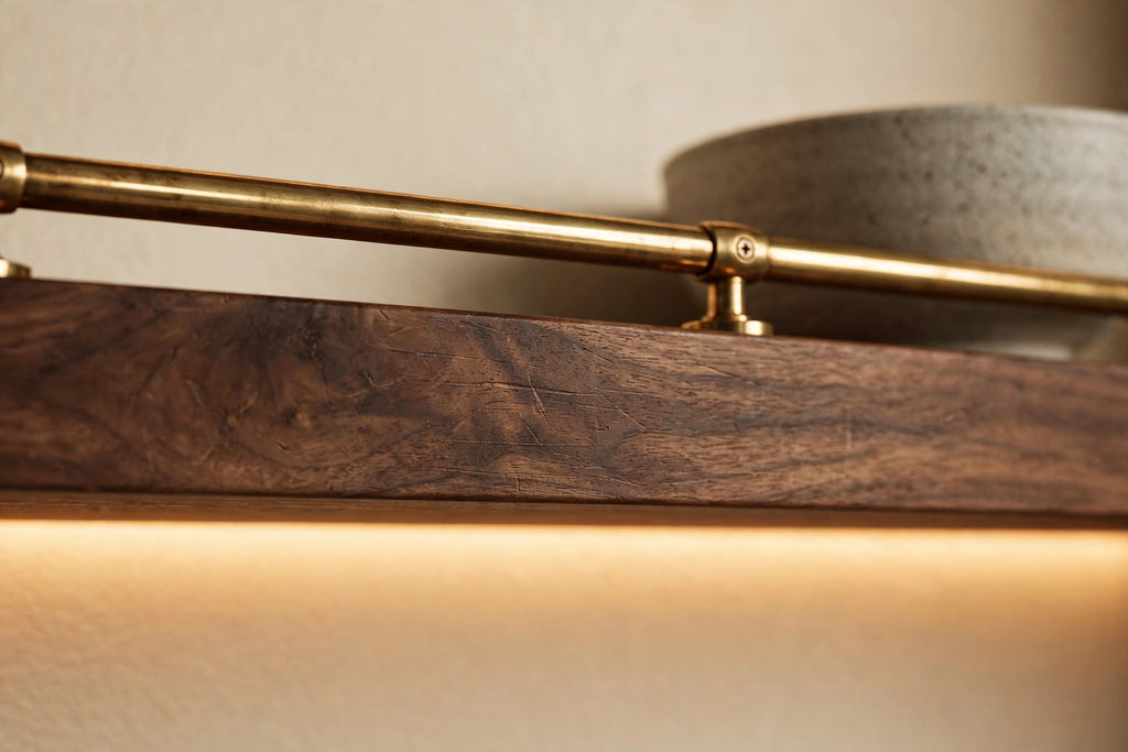Custom lit walnut shelf with brass rail — open storage