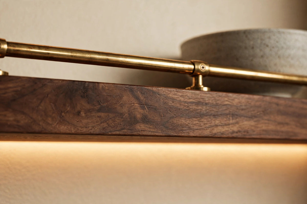 Custom lit walnut shelf with brass rail — open storage
